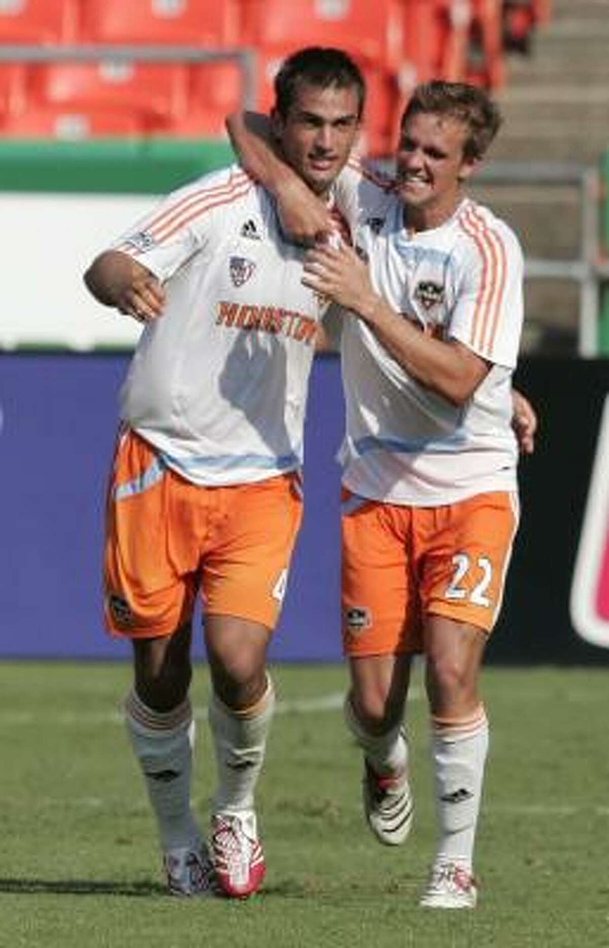 The Dynamo's Patrick Ianni, left, and Stuart Holden celebrate after hooking up on the game-winning goal against the Wizards at Kansas City, Mo.
