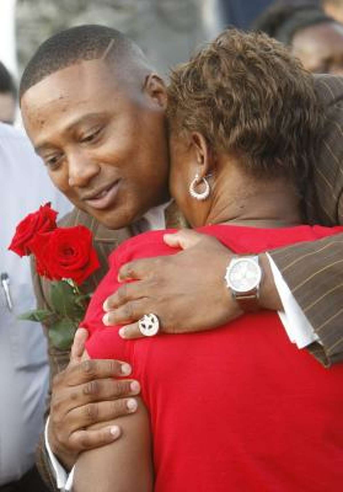 Quanell X hugs Gale Shields, Tynesha Stewart's mother, at a candlelight vigil on Thursday. Suspect Timothy Wayne Shepherd led Quanell X to where Shepherd said he dumped Stewart's body.