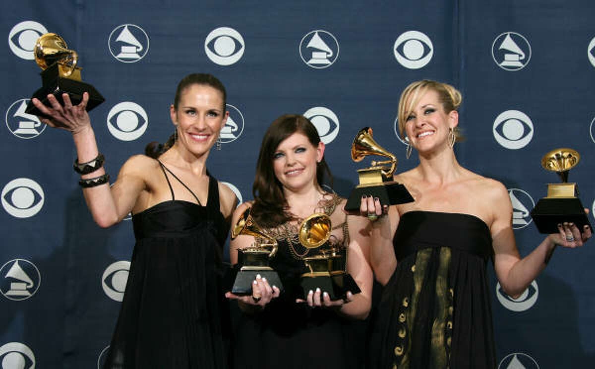 Members of the Dixie Chicks, Emily Robison, left, Natalie Maines and Martie Maguire, pose with their trophies at the 49th Grammy Awards in Los Angeles on Feb. 11.