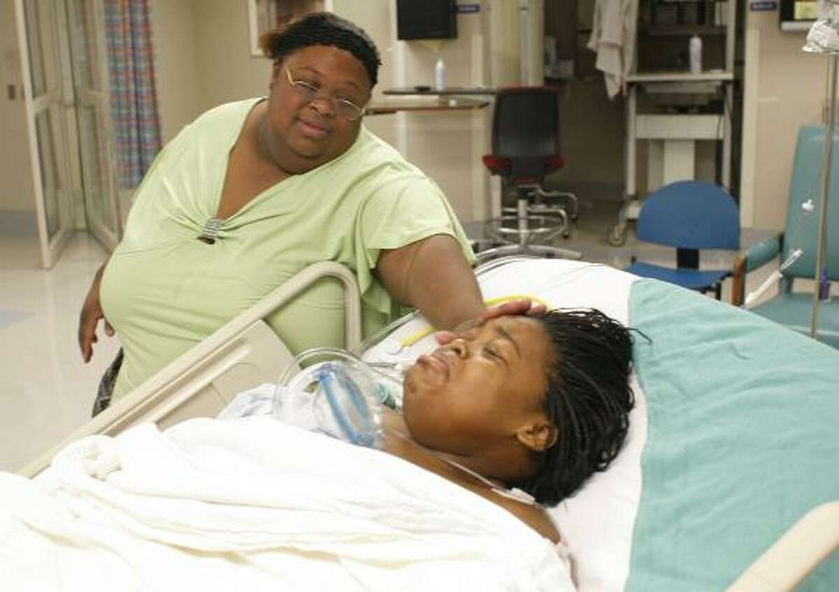 Trina Gulley, left, checks on her daughter, KeAira Willis, 17, after she arrives in the recovery room at Texas Children's Hospital after the first of two procedures to remove the excess skin that resulted from dramatic weight loss. A second surgery will be done in about four months.