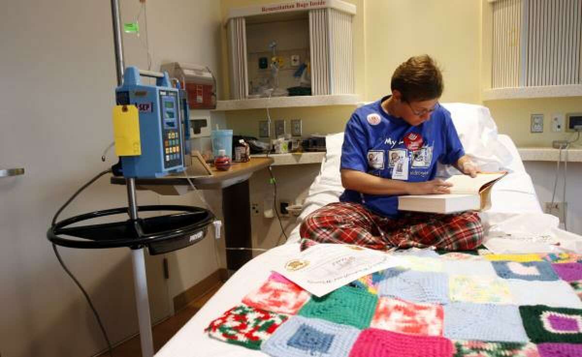 Jacob Henski, 16, of Katy, is awaiting a lung and heart transplant at Texas Children's Hospital. He passes time reading Harry Potter and the Deathly Hallows, one of 200 books donated to patients by Amegy Bank.