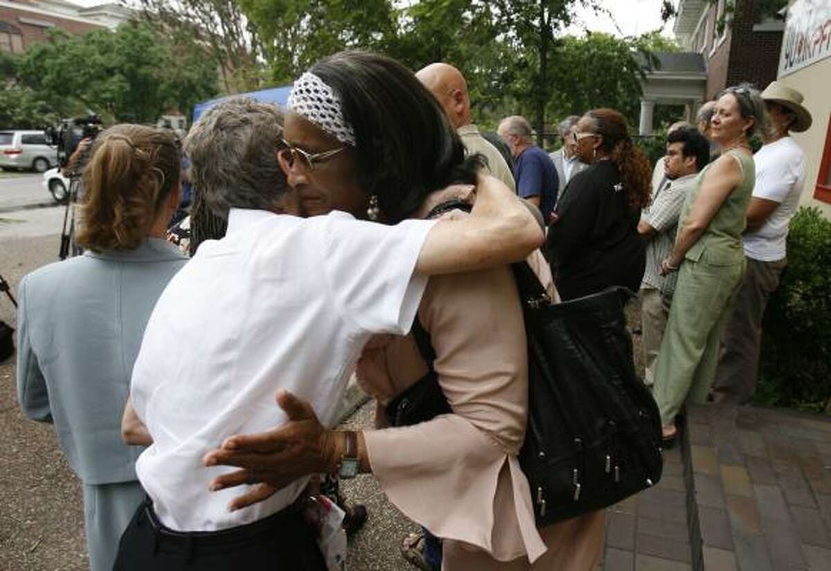 Mary Thomas, right, receives a show of support from a friend Wednesday outside the KPFT studio in Montrose.