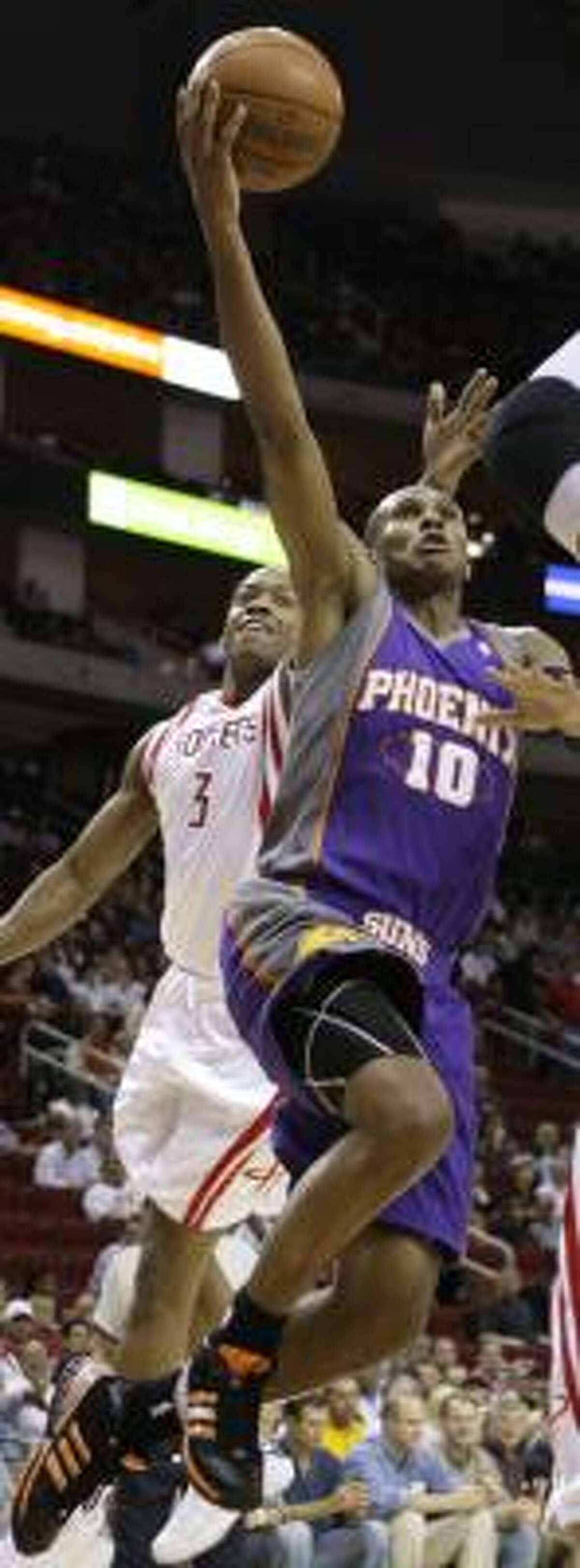 Steve Francis, left, takes a swipe at a shot by the Suns' Leandro Barbosa on Saturday night.
