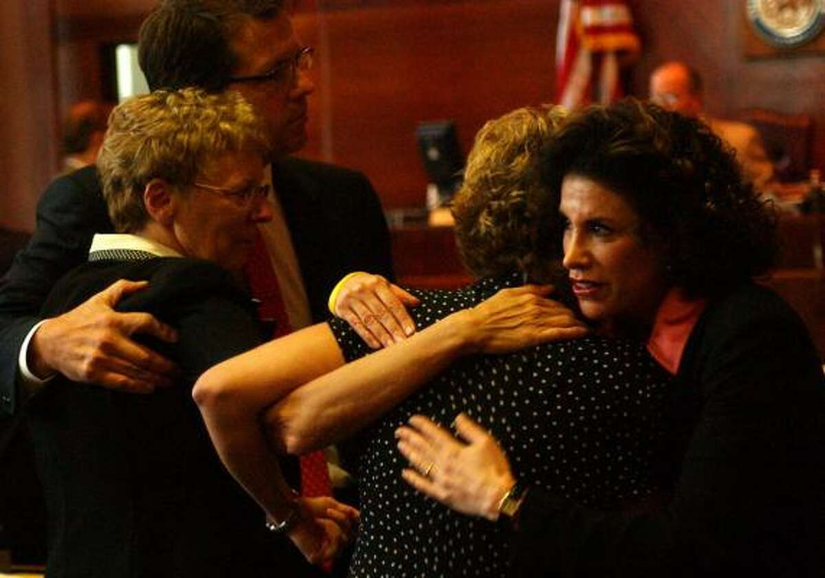 Carol Ernst, left, attorney Mark Lanier, Ernst's daughter Shawna Sherrill and attorney Lisa Blue hug after Sherrill's testimony in the 2005 Vioxx trial.
