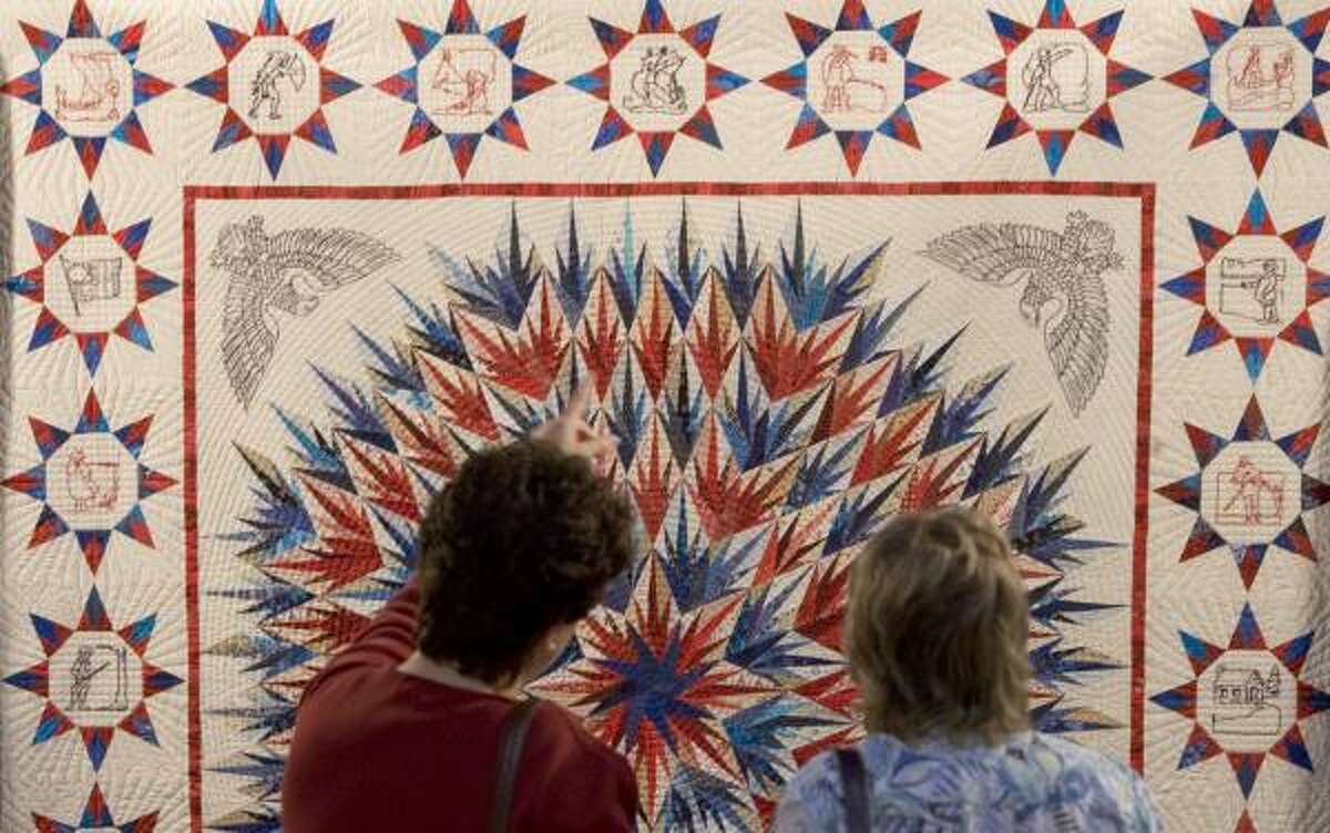 Valli Schiller, left, and Stephanie Nordlin pause to take a look at one of the quilts on display during a special winners' preview at the International Quilt Festival at the George R. Brown Convention Center.