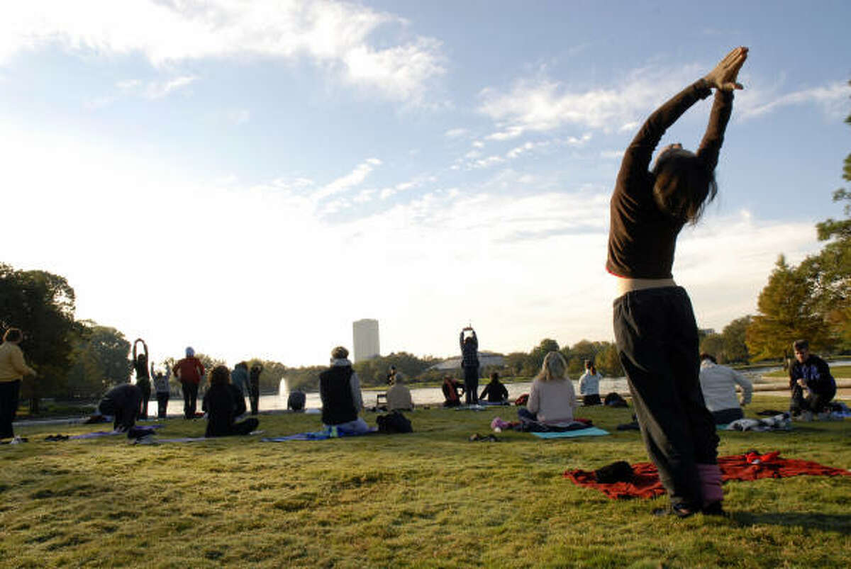 Yoga practicioners enjoy the green spaces at Hermann Park.