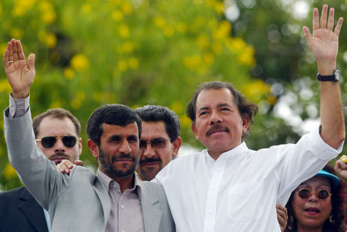 Iranian President Mahmoud Ahmadinejad and Nicaraguan President Daniel Ortega wave to supporters during a visit to the working-class neighborhood "Cuba Libre" in Managua. Ahmadinejad was on a Latin American tour to round up anti-U.S. allies. He promised closer ties to Nicaragua. Ortega said the visit was "not merely a matter of protocol."