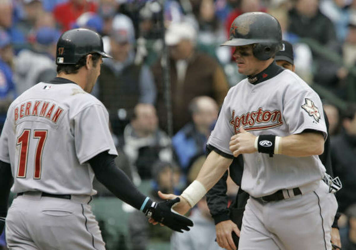 Houston's Craig Biggio is congratulated by Lance Berkman after Biggo scored on a double by Chris Burke.