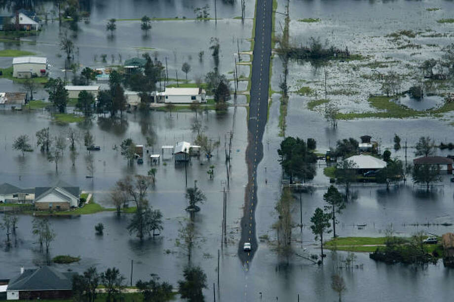 Narrows | A road peeks out of the high waters surrounding several homes. | Sept. 14 | Winnie Photo: Smiley N. Pool, Houston Chronicle