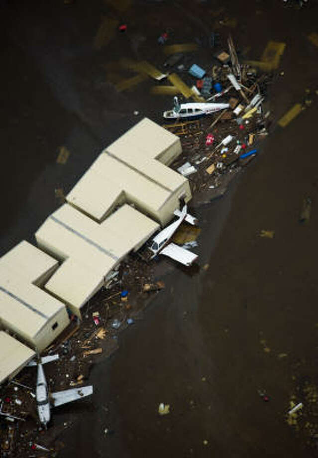 Havoc | Debris surrounds damaged aircraft and hangars at Scholes International Airport. | Sept. 13 | Galveston Photo: Smiley N. Pool, Houston Chronicle
