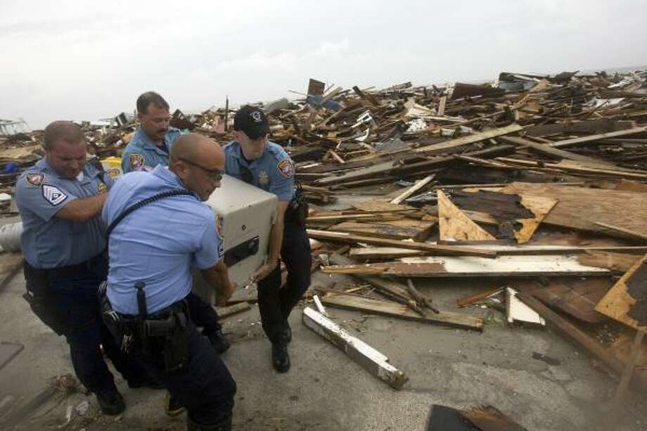A safe place | Police remove a safe from the rubble of the Hooters restaurant on Seawall Boulevard. | Sept. 13 | Galveston Photo: Johnny Hanson, Houston Chronicle