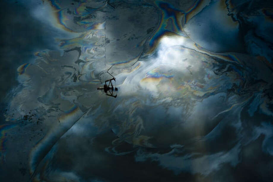 Shimmer | A sheen of oil is seen in the floodwaters surrounding a pump jack. | Sept. 14 | High Island Photo: Smiley N. Pool, Houston Chronicle