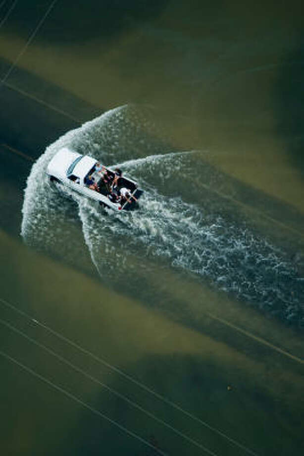 Drive through| A pickup truck loaded with passengers in its bed braves the high waters. | Sept. 14 | High Island Photo: Smiley N. Pool, Houston Chronicle