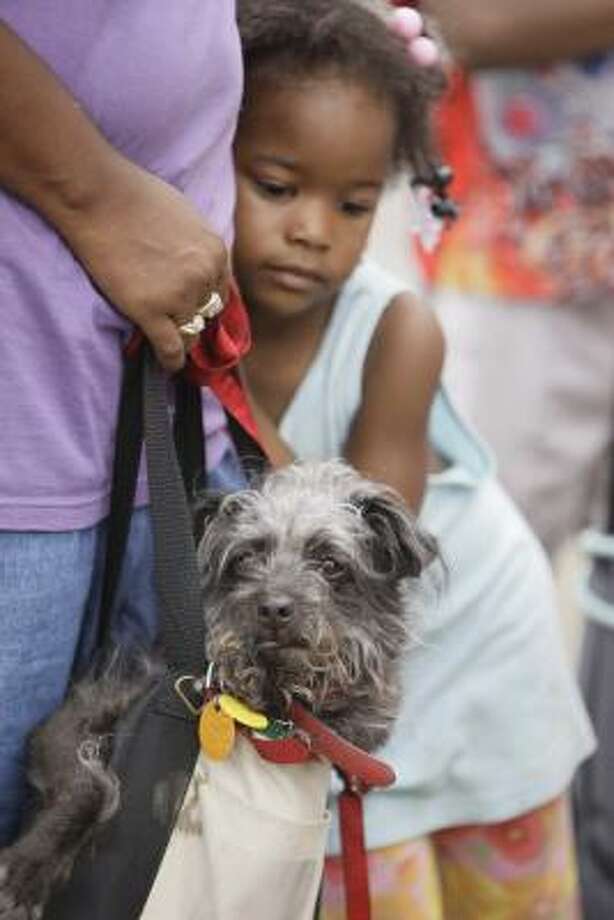 Packed | Joyce Earls and her daughter, Derica Williams, 4, wait with Blackie the dog for an evacuation bus. | Sept. 14 Photo: Melissa Phillip, Houston Chronicle