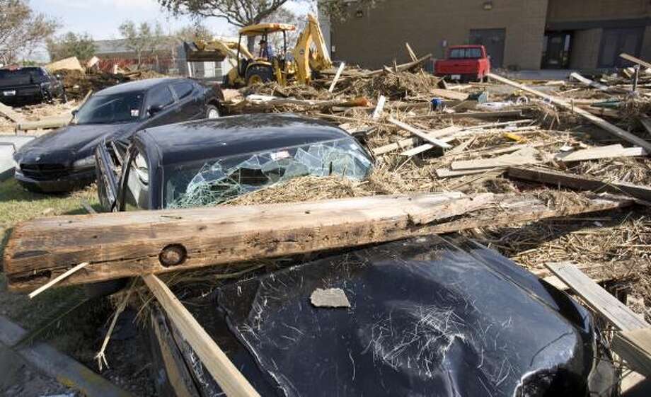 Immovable objects | Cars are trapped under debris at a Coast Guard station. | Sept. 15 | Galveston Photo: Brett Coomer, Houston Chronicle