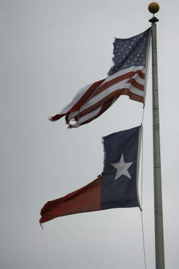 Torn but still aloft | Tattered flags flutter in the wind. | Sept. 13 | League City Photo: Nick De La Torre, HOUSTON CHRONICLE