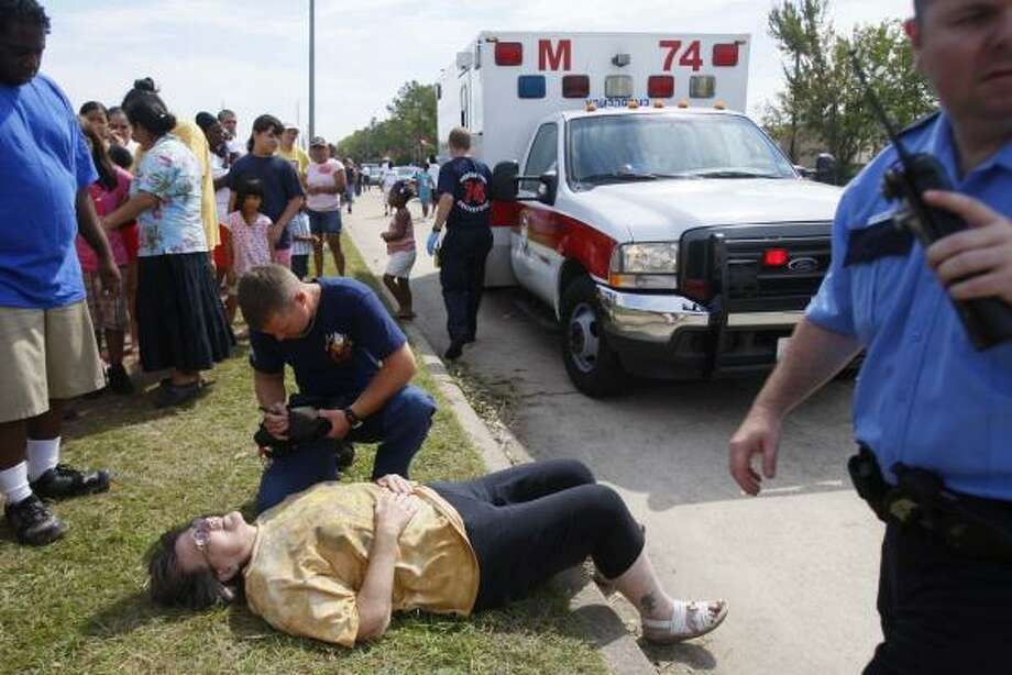 In need | A woman fell ill and was taken to a nearby hospital while waiting in line to get supÂplies such as water, ice and MREs at a FEMA distribution hub on Imperial Valley and Greens. | Sept. 15 | Houston Photo: Mayra Beltran, Houston Chronicle