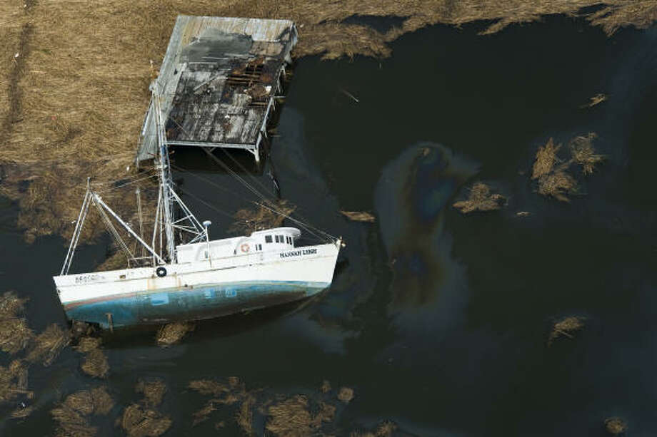 Upended | A boat is overturned along Texas 73. | Sept. 14 | Winnie Photo: Smiley N. Pool, Houston Chronicle