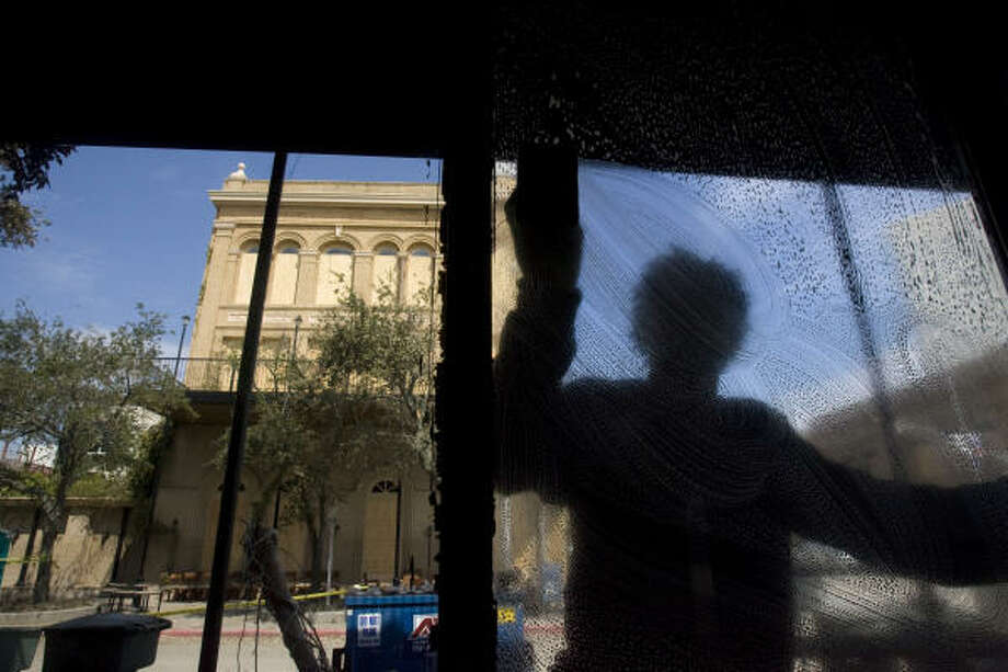 A clearer view| Steven Frasier, a contract worker from Georgia, cleans windows at the Stork Club. | Sept. 18 | Galveston Photo: Johnny Hanson, Houston Chronicle