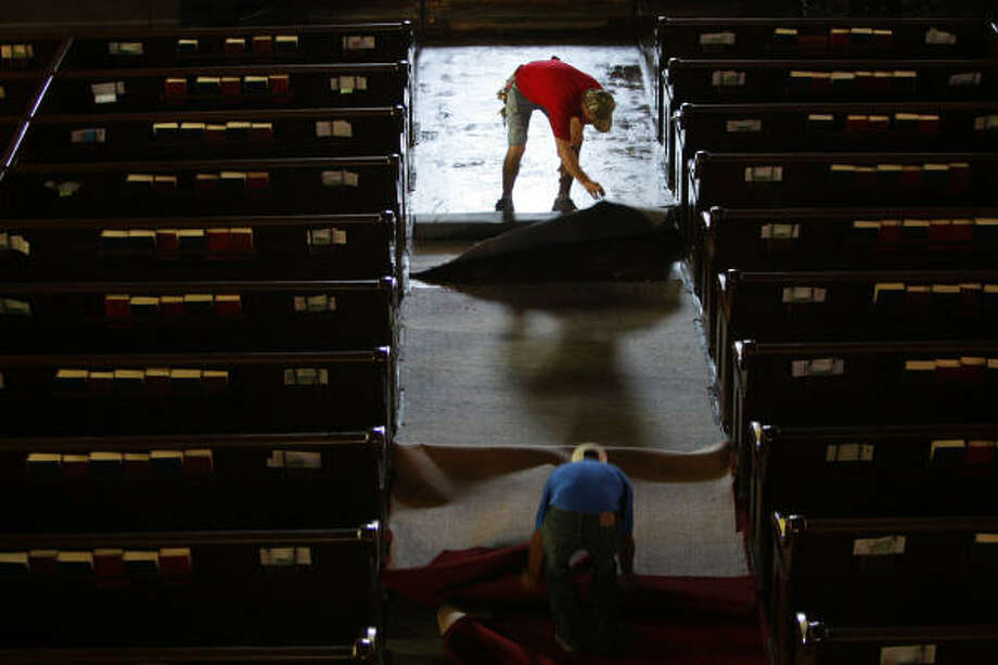 House of worship | Workers remove wet carpet at the historical Trinity Episcopal Church, which flooded during the hurricane. | Sept. 18 | Galveston Photo: Mayra Beltran, Houston Chronicle