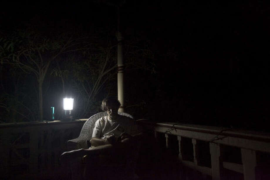 Game's on | Mike Gilbert, an Astros season-ticket holder, listens to the play by play on the radio as the team faces off against the Florida Marlins. Gilbert said he plans on staying even though his East End home is still without power. | Sept. 18 | Galveston Photo: Johnny Hanson, Houston Chronicle