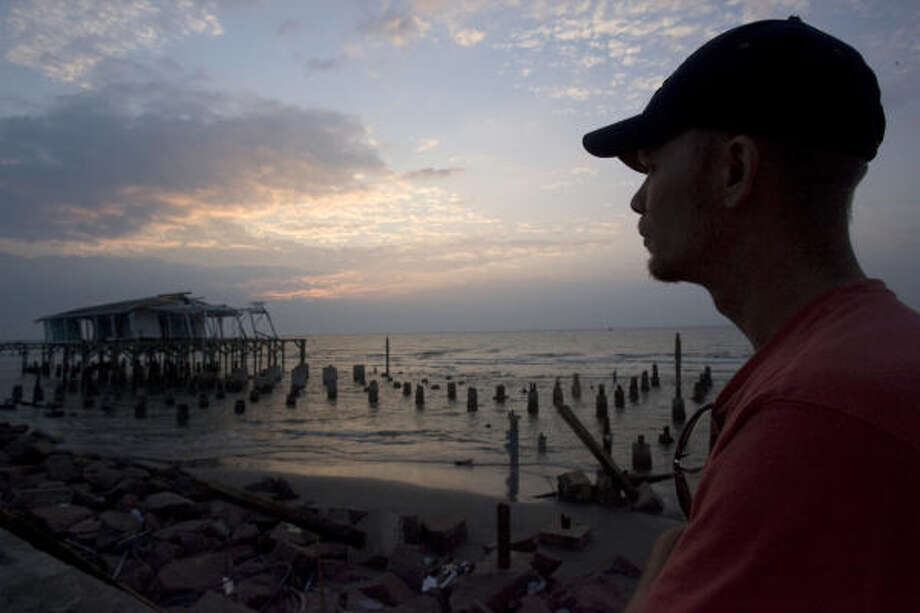 Lost memories | Ralph Crawford Jr. of Conroe came to town to clean debris along the Seawall. "I'm sad for Galveston," Crawford said, standing near Murdock's Pier. "I see people's lives and memories in what we are cleaning up." | Sept. 19 | Galveston Photo: Johnny Hanson, Chronicle
