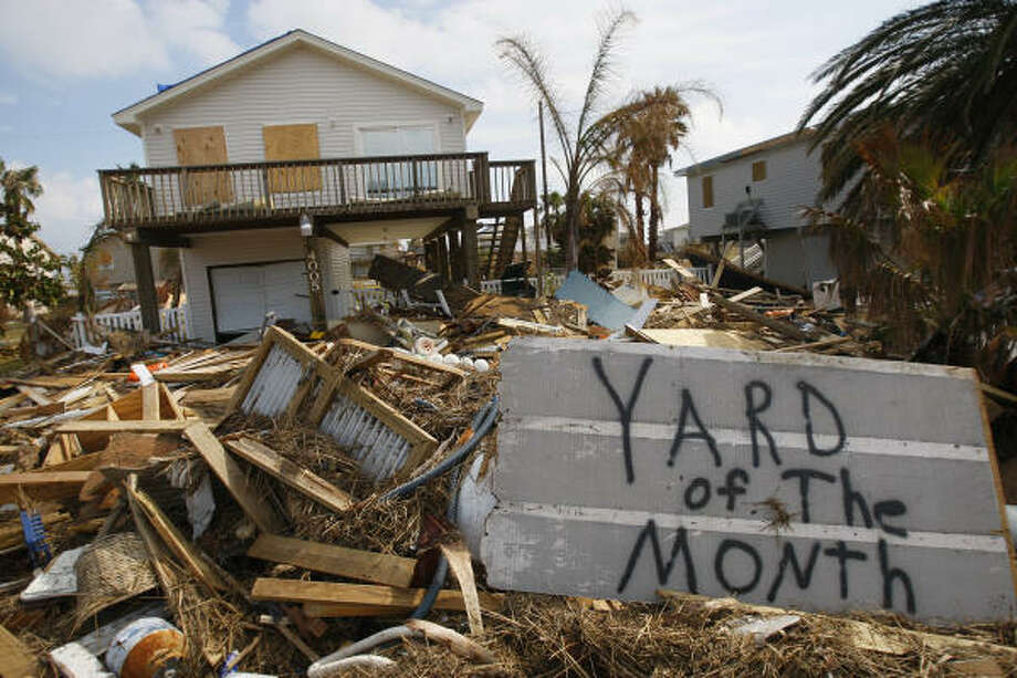 Humor | Debris litters the front yard of a home in the West End's Sea Isle subdivision as residents arrive to assess their homes 10 days after the hurricane. | Sept. 23 | Galveston Photo: Mayra Beltran, Houston Chronicle