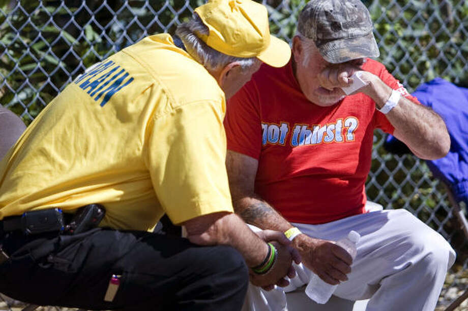 Consoled| Chaplain Wade Mathis consoles a hurricane evacuee as a group returns from a San Antonio shelter. "I know a Marine isn't supposed to cry," the evacuee said. | Oct. 1 | Galveston Photo: Nick De La Torre, HOUSTON CHRONICLE