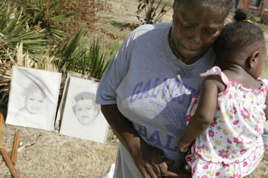 Hanging by a thread | Catherine Malone holds her great-granddaughter, 9-month-old Veruschka Matthews, outside her destroyed apartment at a public housing complex. The complex was condemned and residents are being forced to leave. "I don't have no help," Malone said. "No husband, no boyfriend, no son." | Sept. 26 | Galveston Photo: Eric Kayne, Chronicle