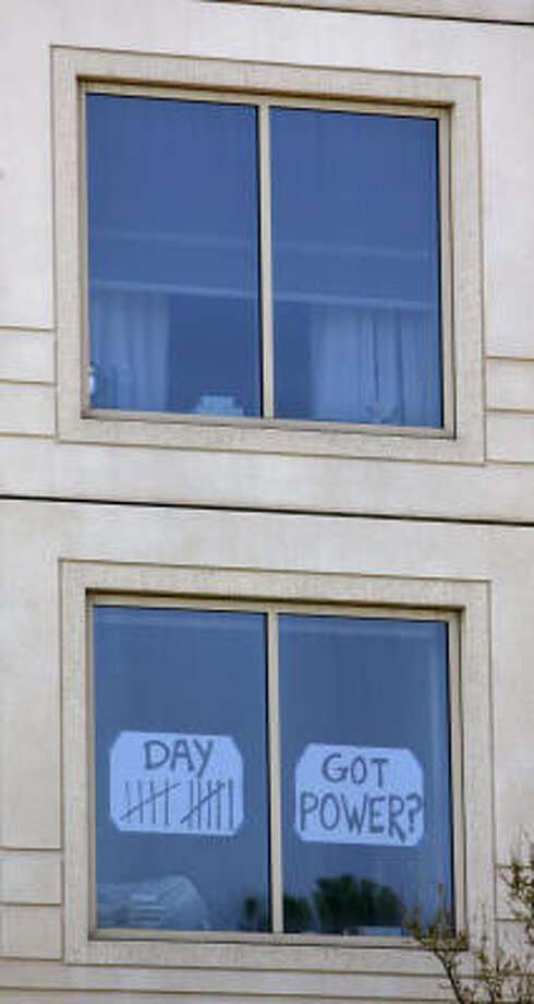 Maybe soon | A sign in a window of a high-rise on Allen Parkway expresses the frustration of many in the same dark situation. | Sept. 25 | Houston Photo: Karen Warren, Houston Chronicle