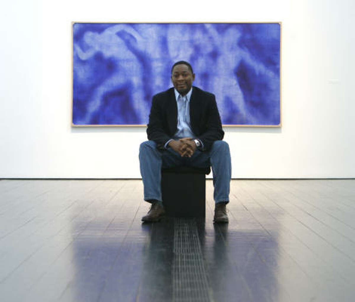 Franklin Sirmans, Menil Collection curator of modern and contemporary art, sits in front of Yves Klein's Hiroshima.