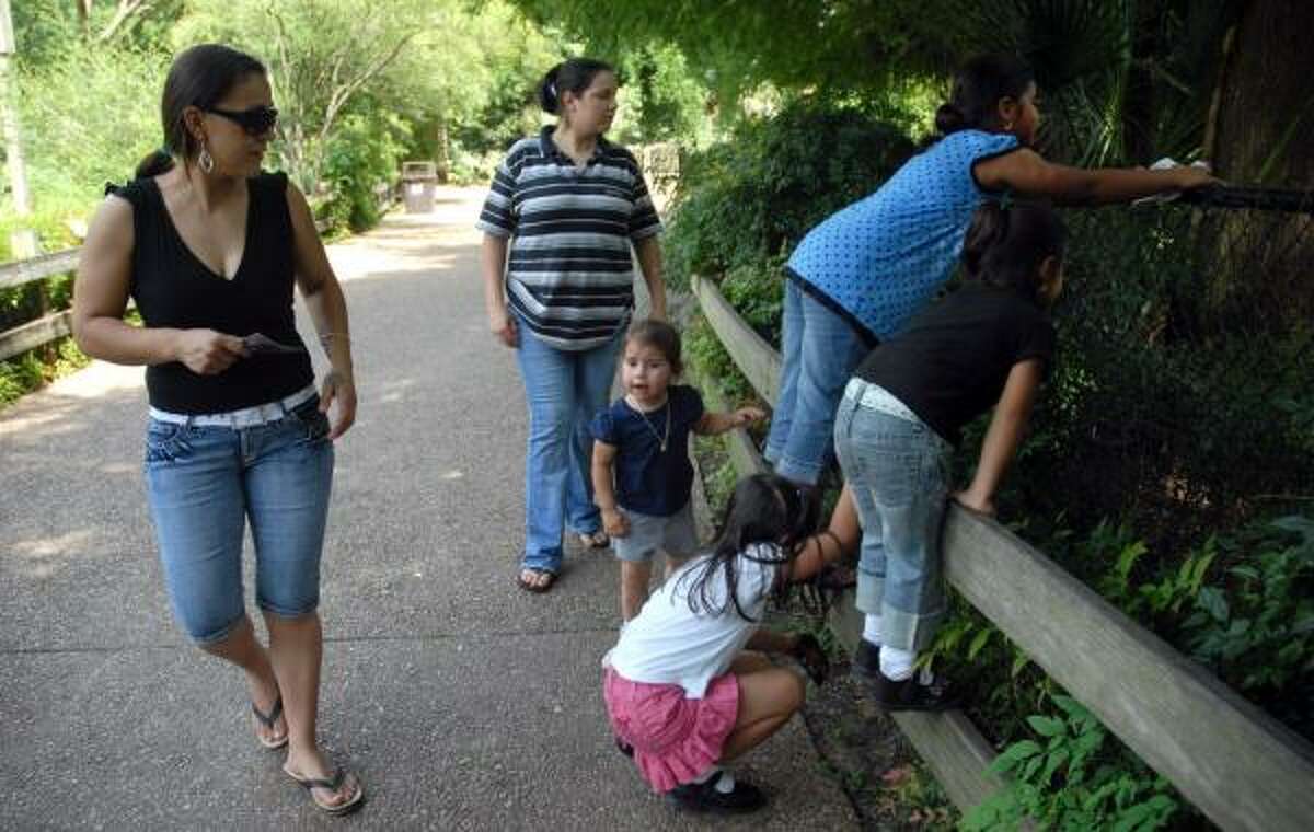 Gabriela Yanez, left, and her sister, Arcenia, and their children, spent Thursday afternoon at the Hermann Park menagerie. Yanez said she is disappointed that zoo admission will be going up to $10 for adults and $5 for children.