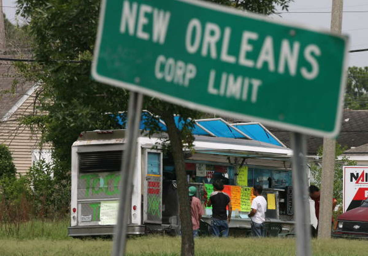 Day laborers meet at a taqueria truck just inside Orleans Parish, bordering Jefferson Parish where a new law targets such eateries. In an editorial, a newspaper called the code "intolerant."
