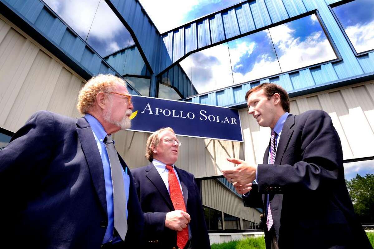 U.S. Congressman Chris Murphy, right, talks with John Edward Pfeifer, Pres. and C.E.O., left, and Sean O'Connor, C.O.O., center, outside their Bethel company, Apollo Solar, Inc. on monday.