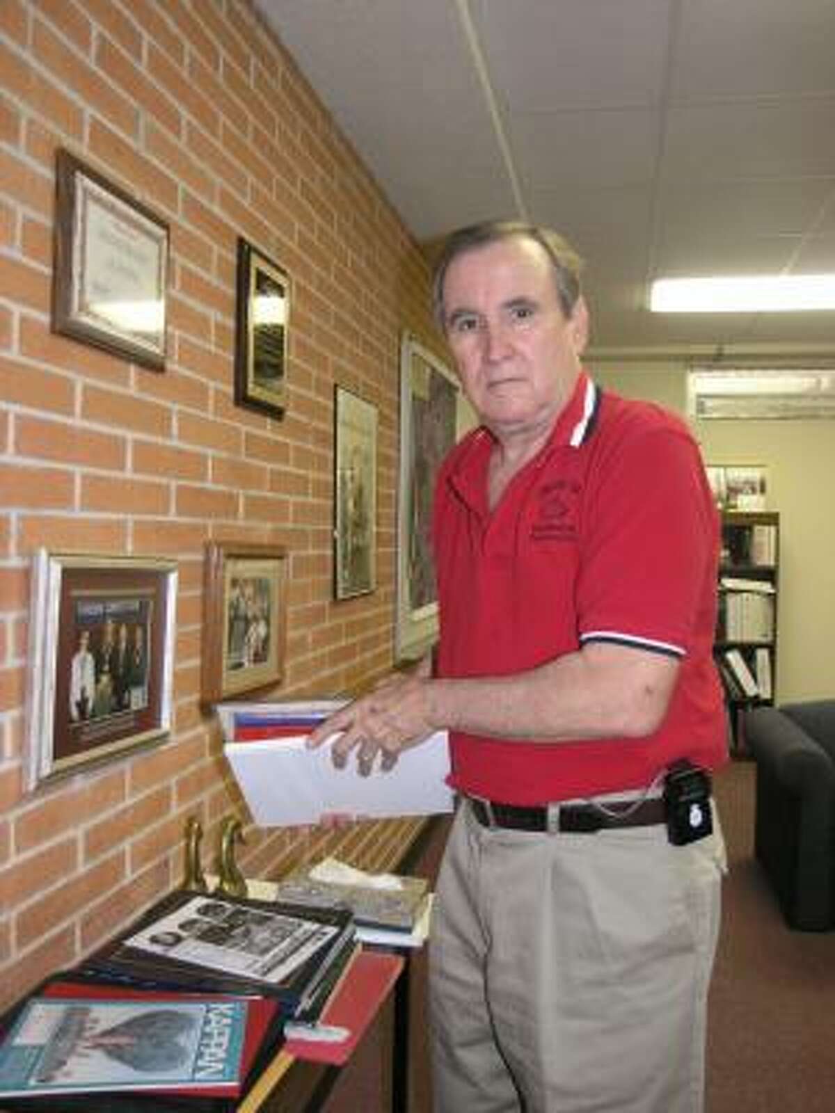 Superintendent Don Hendrix removes special items from his office. During his tenure, Crosby schools have produced graduates who compete against top urban high school graduates for scholarship dollars.