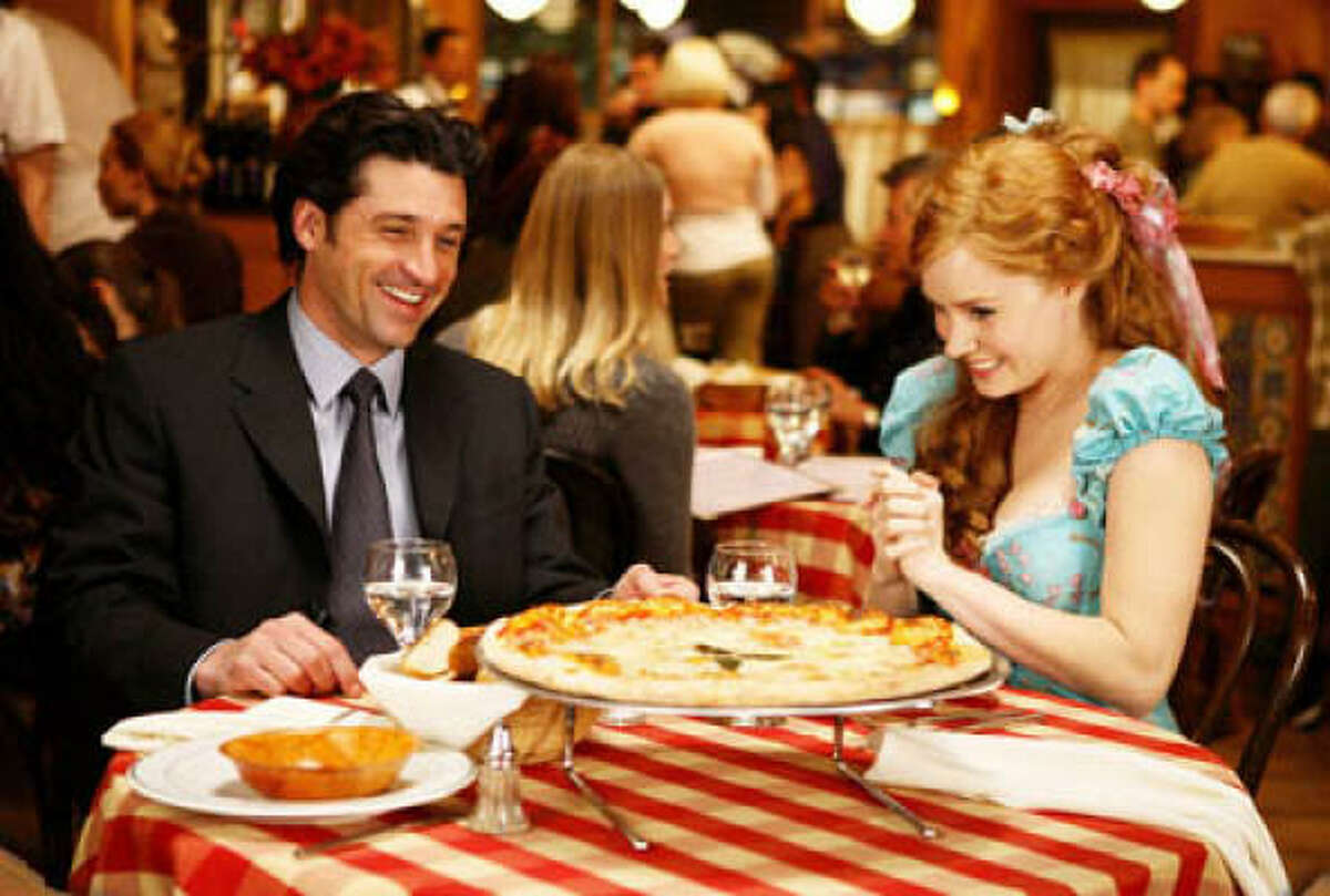 Princess Giselle (Amy Adams) and her newfound love interest, lawyer Robert, share a meal and a laugh in Enchanted.