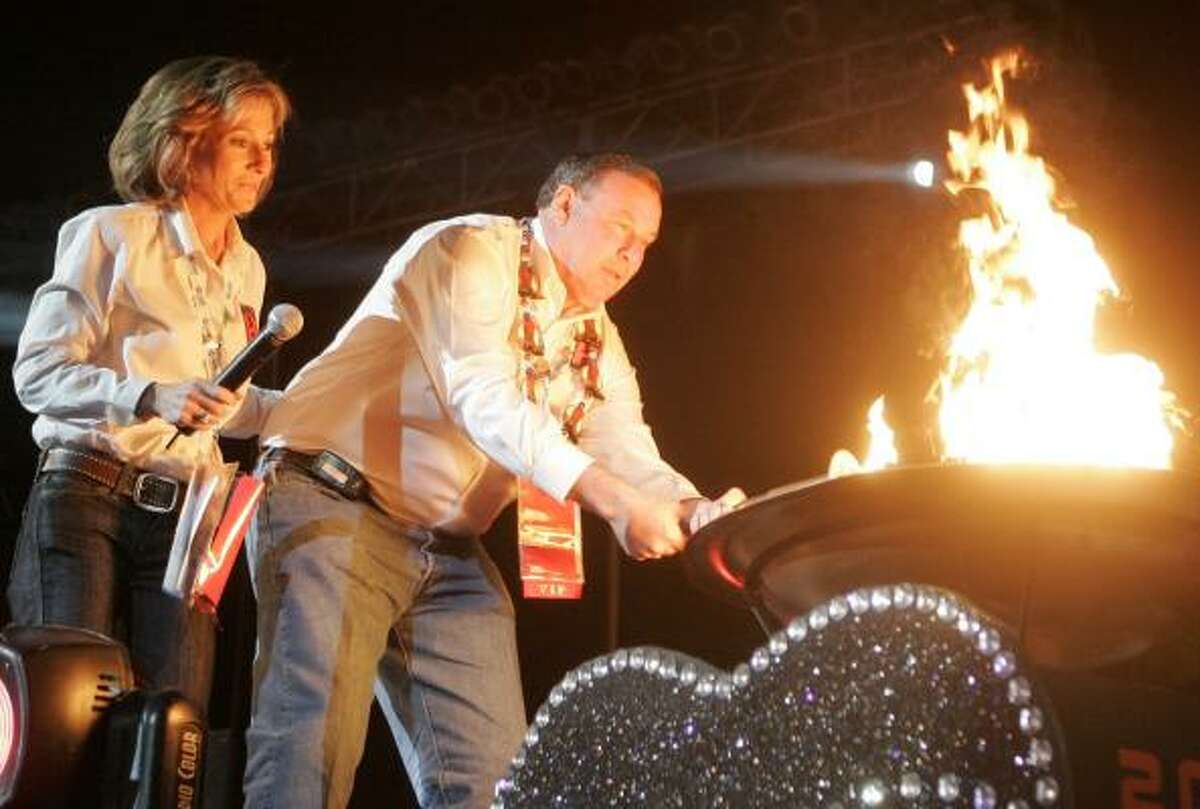 Maccabi Games chairs Wendy Bernstein, left, and Scott Silverman light the torch at the opening ceremonies Sunday night at Toyota Center, signifying the start of the event that will feature 1,700 teenagers in several sports.
