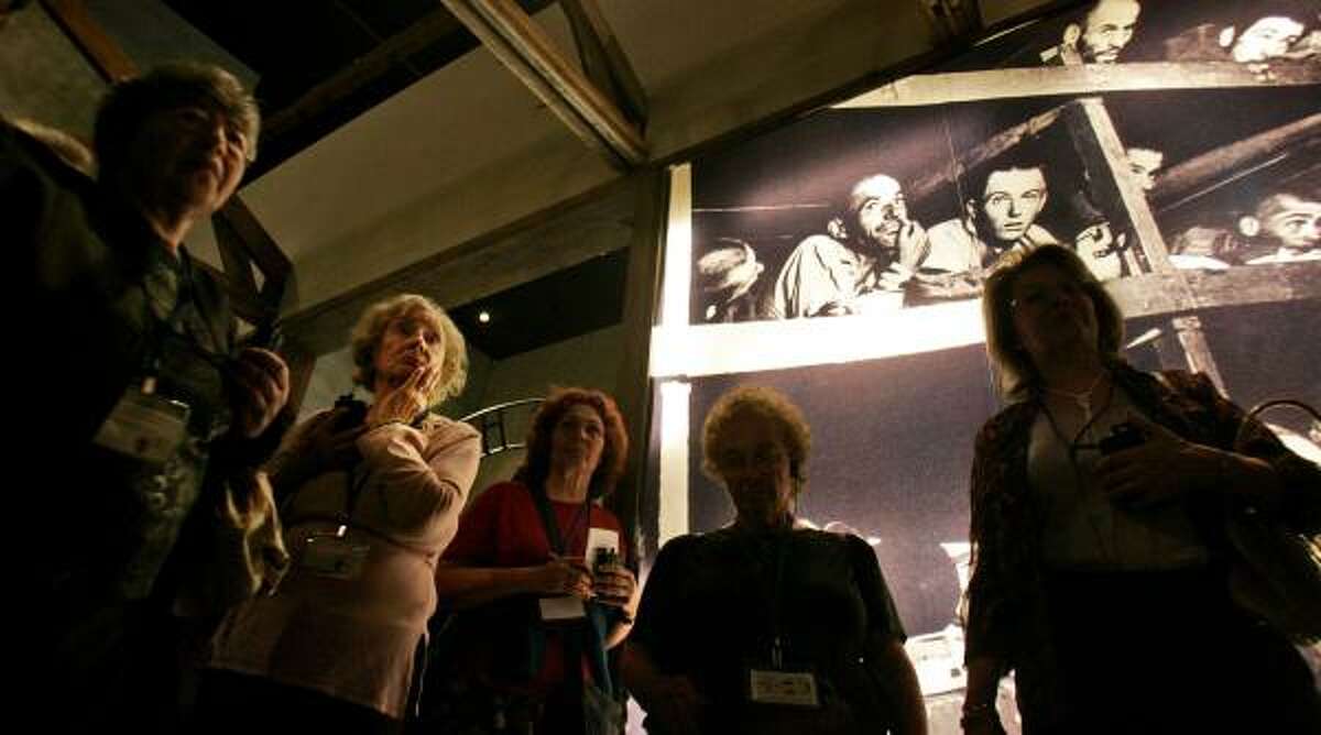 Survivors and relatives tour a Holocaust museum display in Jerusalem. Six million Jews, including 1.5 million children, were murdered by the Nazis in World War II.
