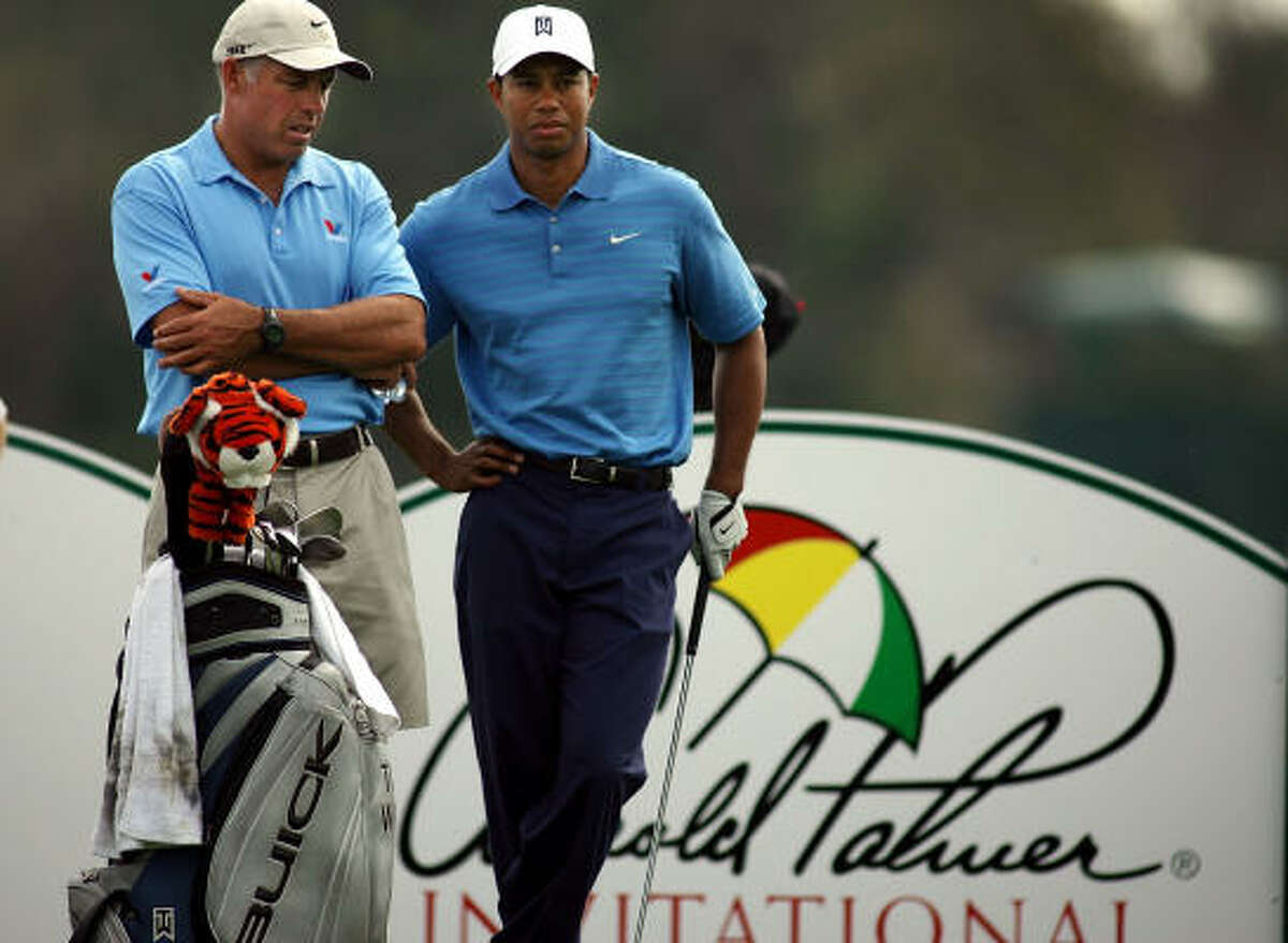 Tiger Woods, right, talks with caddie Steve Williams before teeing off on No. 14 during the Wednesday's pro-am at the Arnold Palmer Invitational at Bay Hill in Orlando, Fla. Woods, who won the event four consecutive years through 2003, will try to end a streak of 11 consecutive rounds at Bay Hill without breaking 70 when he tees off Thursday.