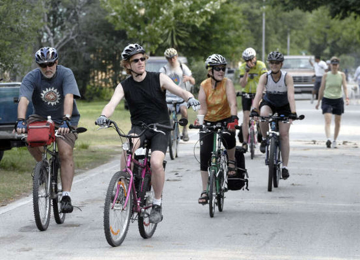 Barry Reese, center, leads a pack of cyclists during the May 5 bike-and-walk event in the Heights, which was meant to draw attention to the proposed Rails to Trails.