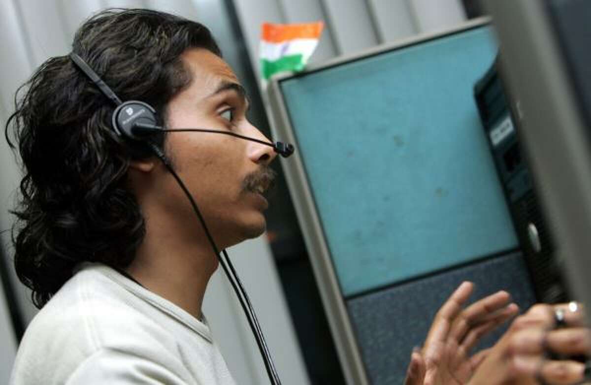 An employee of Convergys Corp., a global leader in call-center outsourcing, speaks with a client in Gurgaon, India.