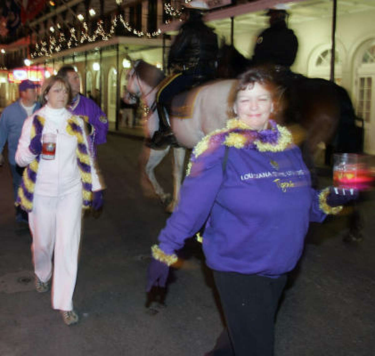 LSU fans navigate Bourbon Street on the eve of the game.