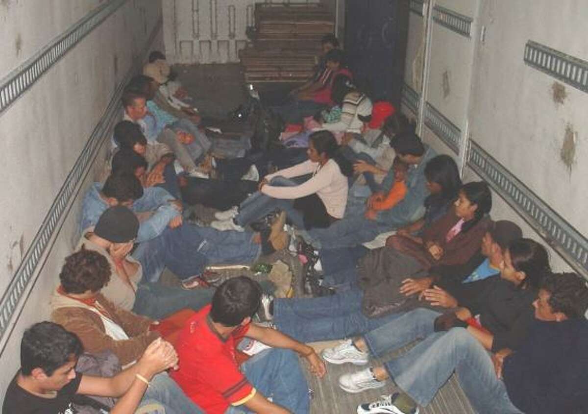 Brazilian immigrants sit inside a trailer after they were discovered by Border Patrol officers at a highway checkpoint near Falfurrias this week. Officers say that stop may have saved the lives of 40 people.