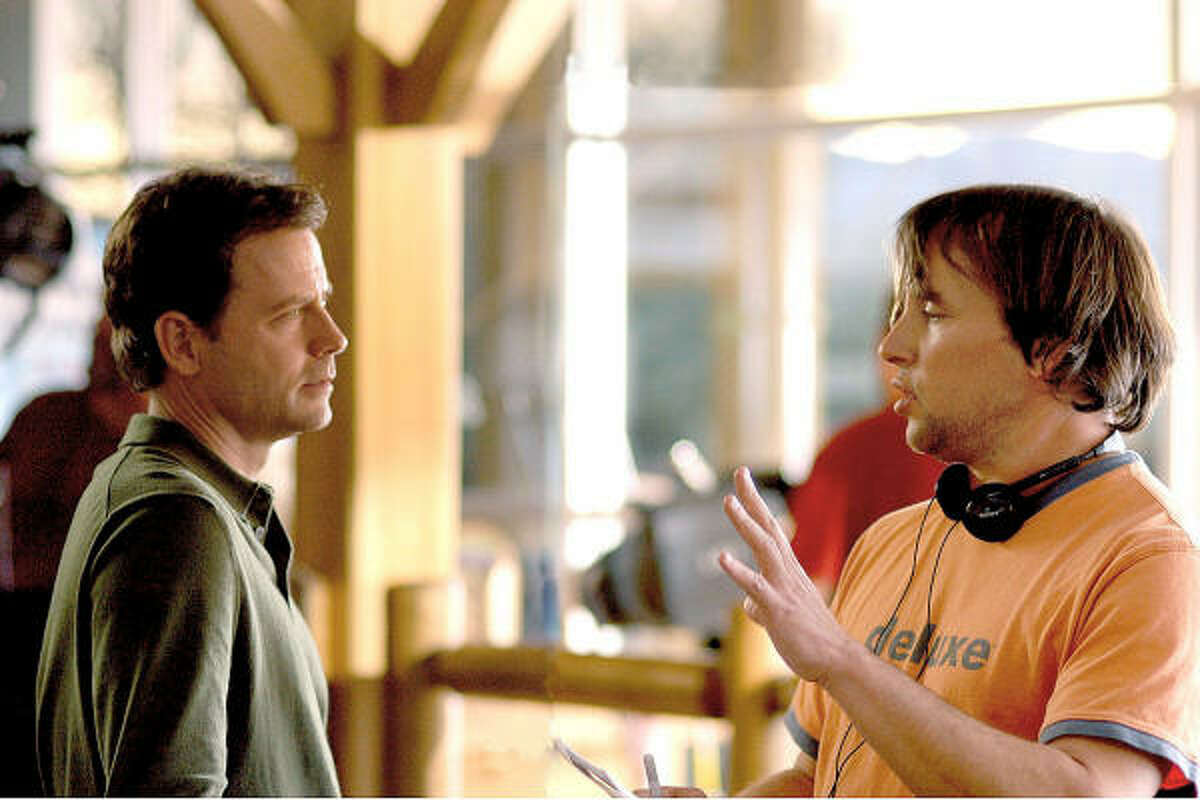 Director Richard Linklater, right, gives instructions to actor Greg Kinnear during the making of Fast Food Nation.