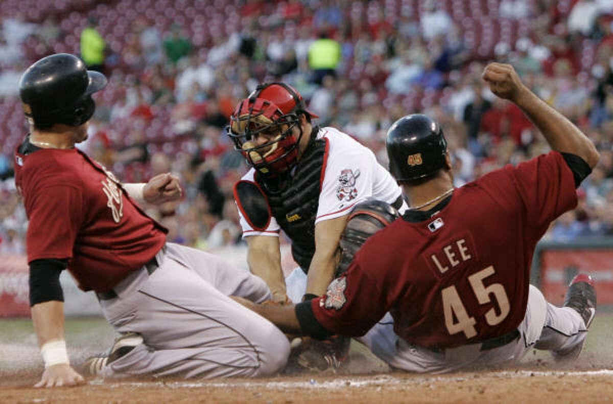 Luke Scott, left, was out and Carlos Lee was safe at home. Lucky for the Astros, they didn't need both.