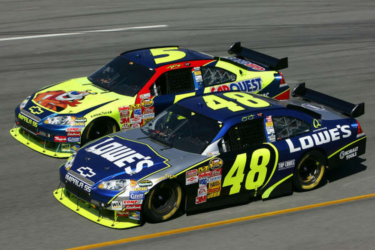 Jimmie Johnson (48) gets by teammate Kyle Busch on his way to victory on Sunday at Richmond International.