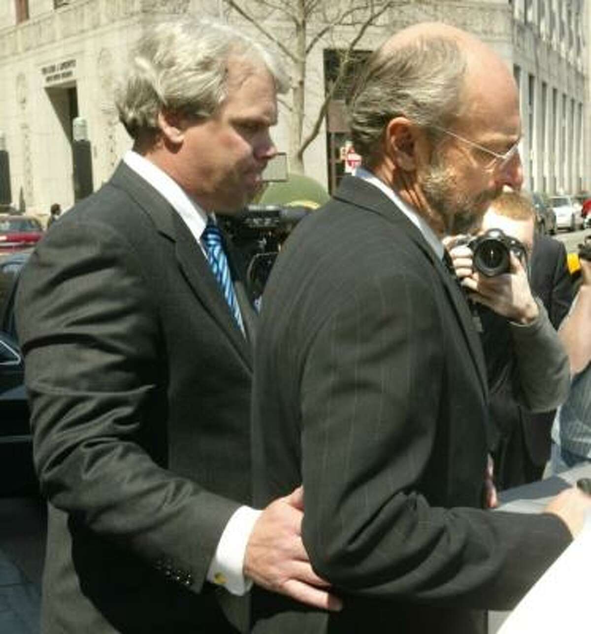 David Chalmers, right, leaves district court in New York in 2006. He could expect to serve 37 to 46 months in prison.