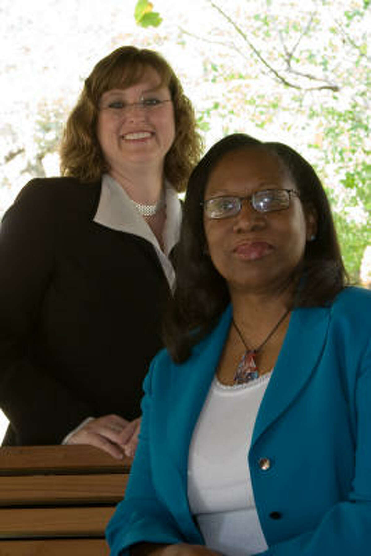 Kim Williamson, back, medicine department administrator in the Gynecologic Medical Oncology Department, and Markettea Beneke, senior department administrator in the Neuro-Oncology Department, have become fast friends as well as colleagues at M D Anderson Cancer Center.