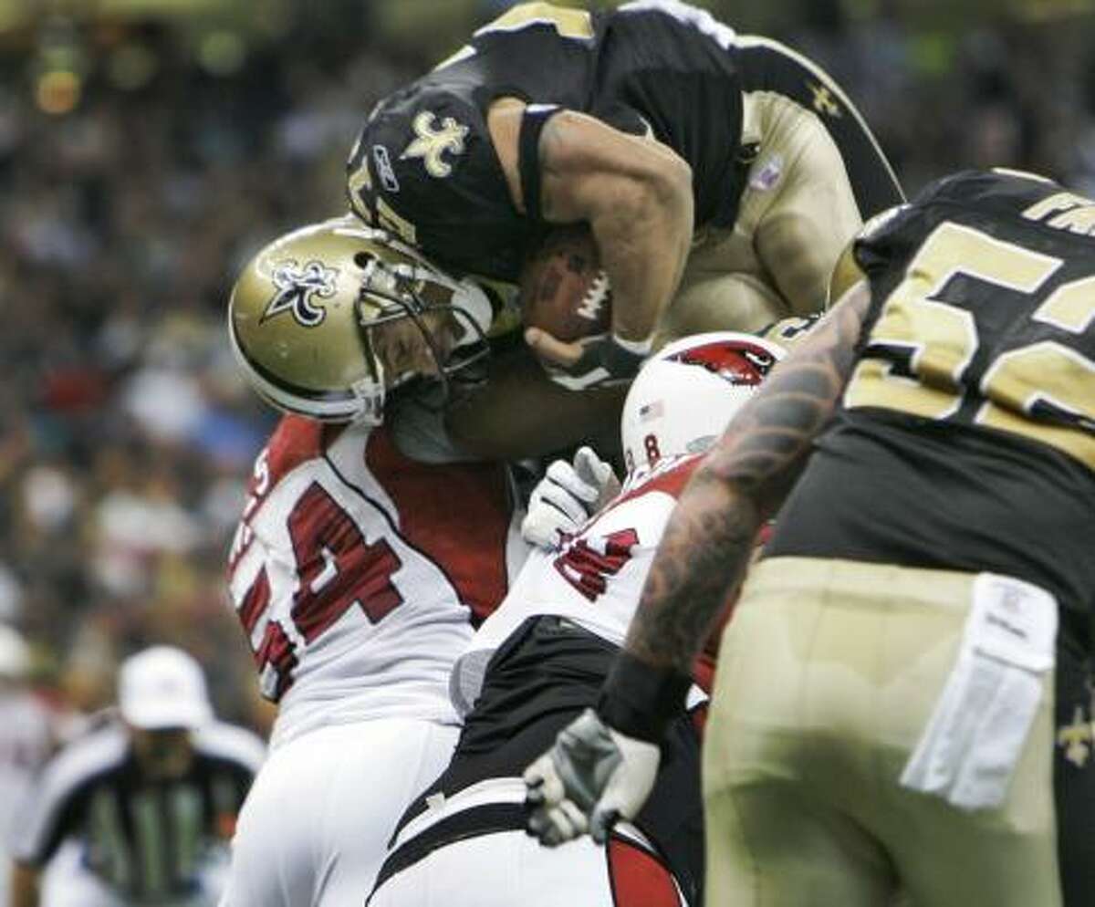 New Orleans running back Aaron Stecker jumps over the line to score a touchdown in the first half of the Saints' win Sunday.