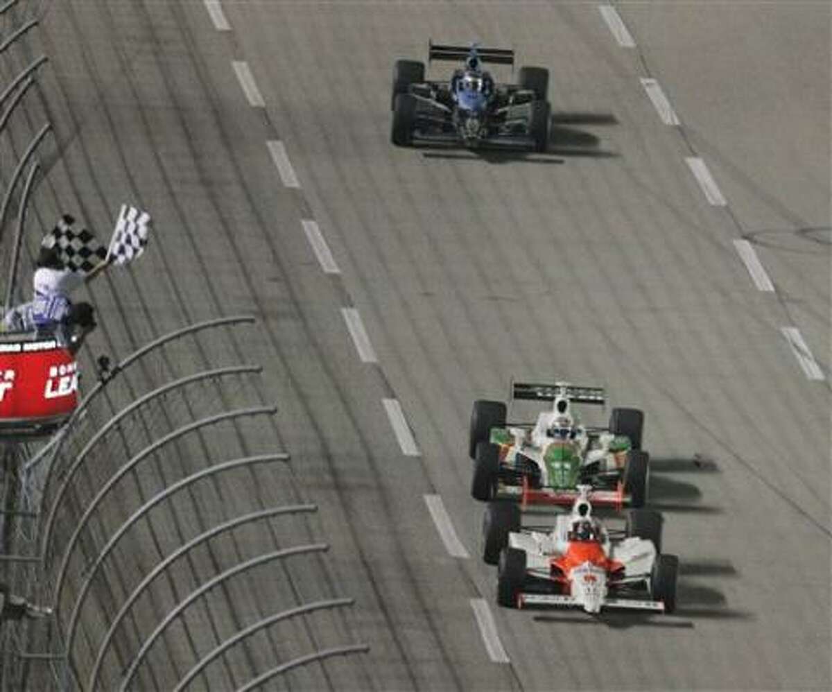 Sam Hornish Jr., bottom, holds off Tony Kanaan and Danica Patrick, top, to win Saturday's main event at Texas Motor Speedway.